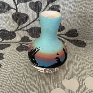 Native American vase signed by artist Dineh. Pottery very colorful